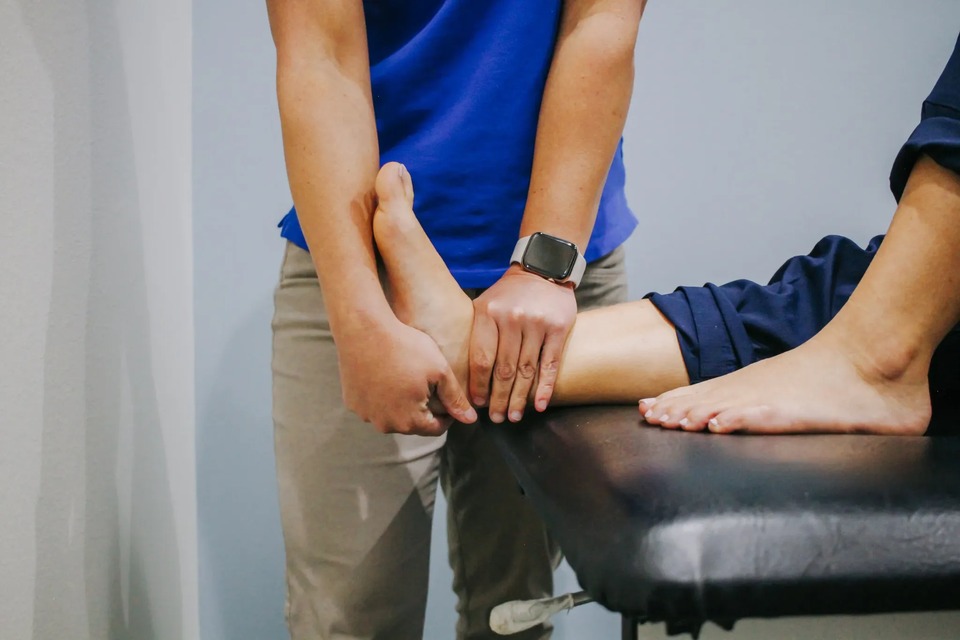 Physiotherapist performing shoulder joint mobilization