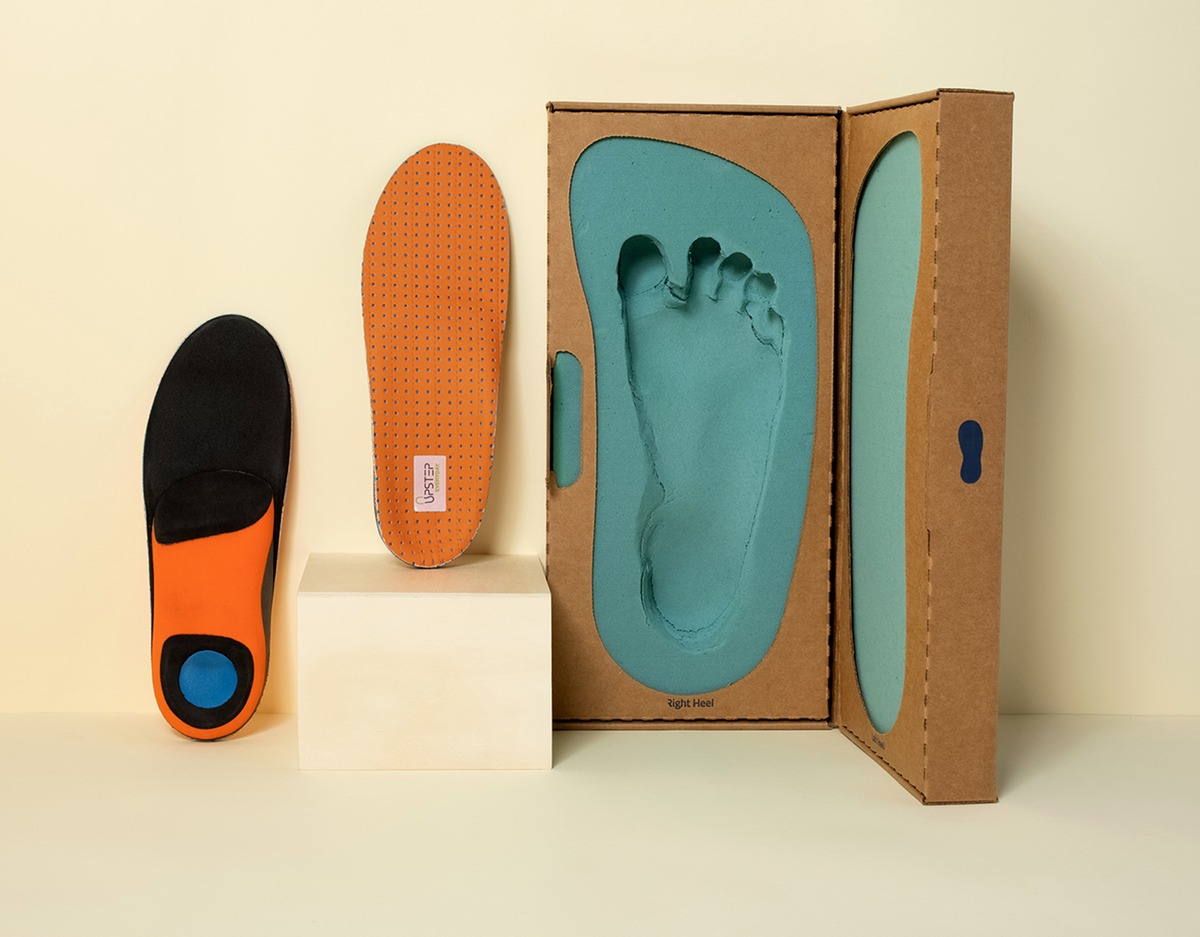 Custom foot orthotics pair on a bench